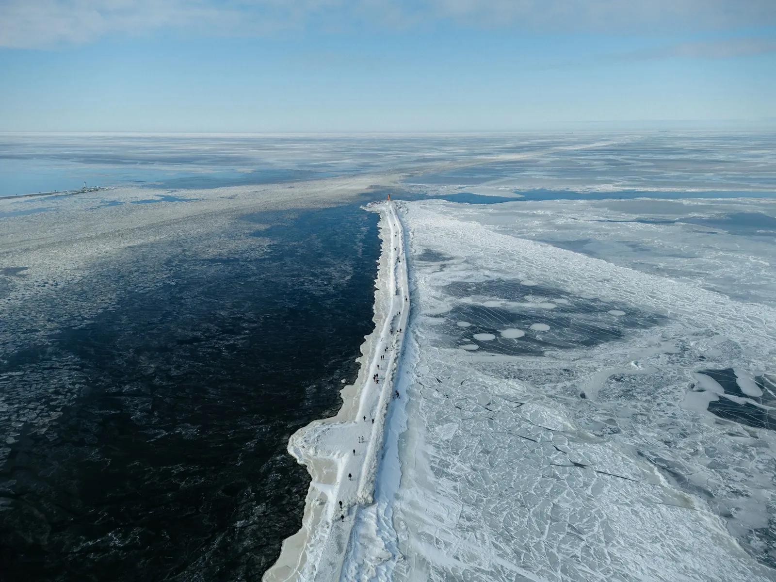 A channel of open water cut through sea ice, seen from above